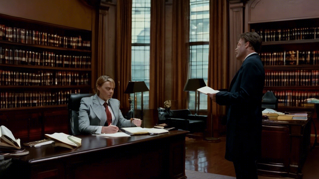 DALL-E prompt: An image of a person sitting in a well-lit, professional law office, holding a notepad with a checklist of consultation questions. The background shows shelves filled with legal books, and a diploma hanging on the wall. The person appears to be attentively listening to a well-dressed attorney seated across a desk, who looks informative and reliable. Keywords like 